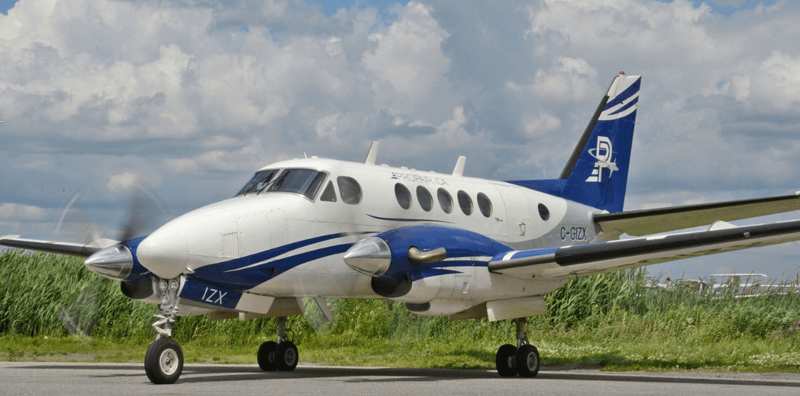 Image of Propair's King Air parked on a runway during the summer.