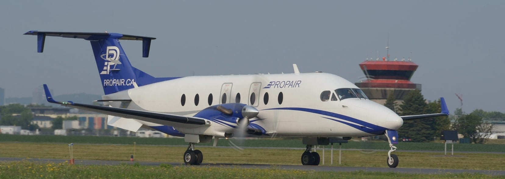 Photo of Propair's B1900D aircraft on a runway during the summer
